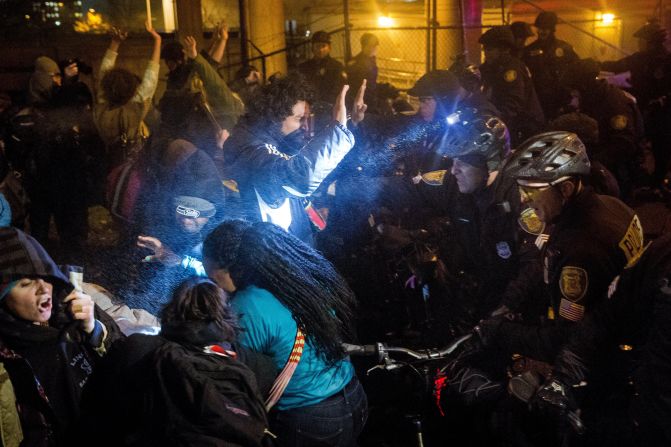 Seattle police attempt to push back protesters with pepper spray and flash-bang grenades on November 24.