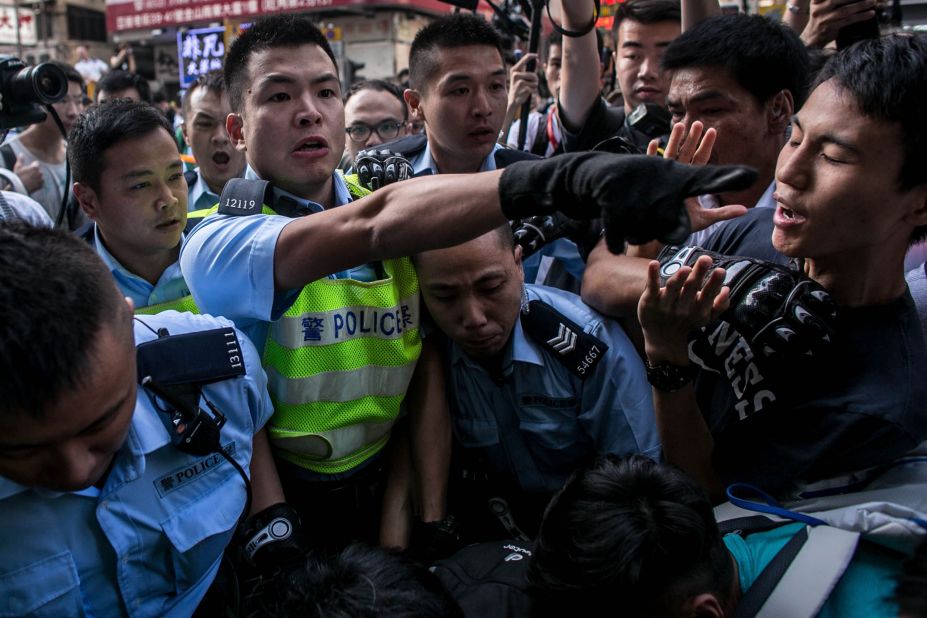 Police clash with protesters as they try to clear a major protest site on Tuesday, November 25. 