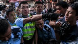 HONG KONG - NOVEMBER 25: Police clash with protesters as they try to clear the street after agents authorized by bailiff's removed barricades on Argyle Street in Mongkok district on November 25, 2014 in Hong Kong. The Mong Kok protest site is scheduled for clearance by baliffs this week after Hong Kong's high court authorized police to arrest protesters who obstruct bailiffs on the three interim restraining orders.  (Photo by Chris McGrath/Getty Images)