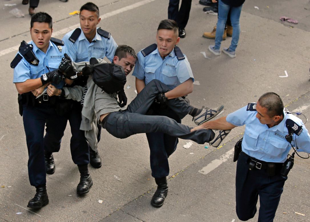 A protester is carried away by police officers on November 25. Hong Kong's high court authorized police to arrest protesters who obstruct clearance of the area.