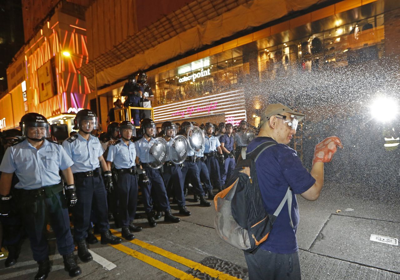 A demonstrator is sprayed with pepper spray by the police after refusing to leave the protest site on November 25.