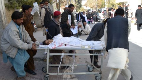 Pakistani volunteers move a health worker wounded in an attack on an anti-polio team in Balochistan on November 26, 2014.