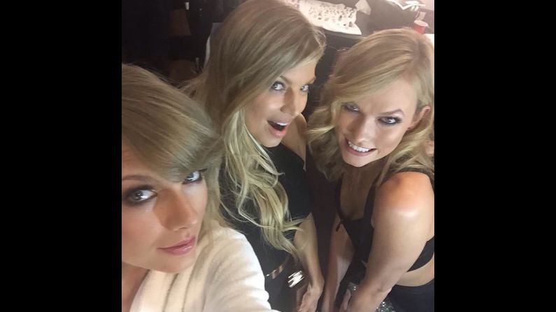 Singer Fergie, center, poses with model Karlie Kloss, right, and singer Taylor Swift <a href="http://instagram.com/p/vxjV9QEDPi/?modal=true" target="_blank" target="_blank">backstage at the American Music Awards</a> on Sunday, November 23. Fergie performed her single "L.A. Love" at the event. Swift received the Dick Clark Award of Excellence.