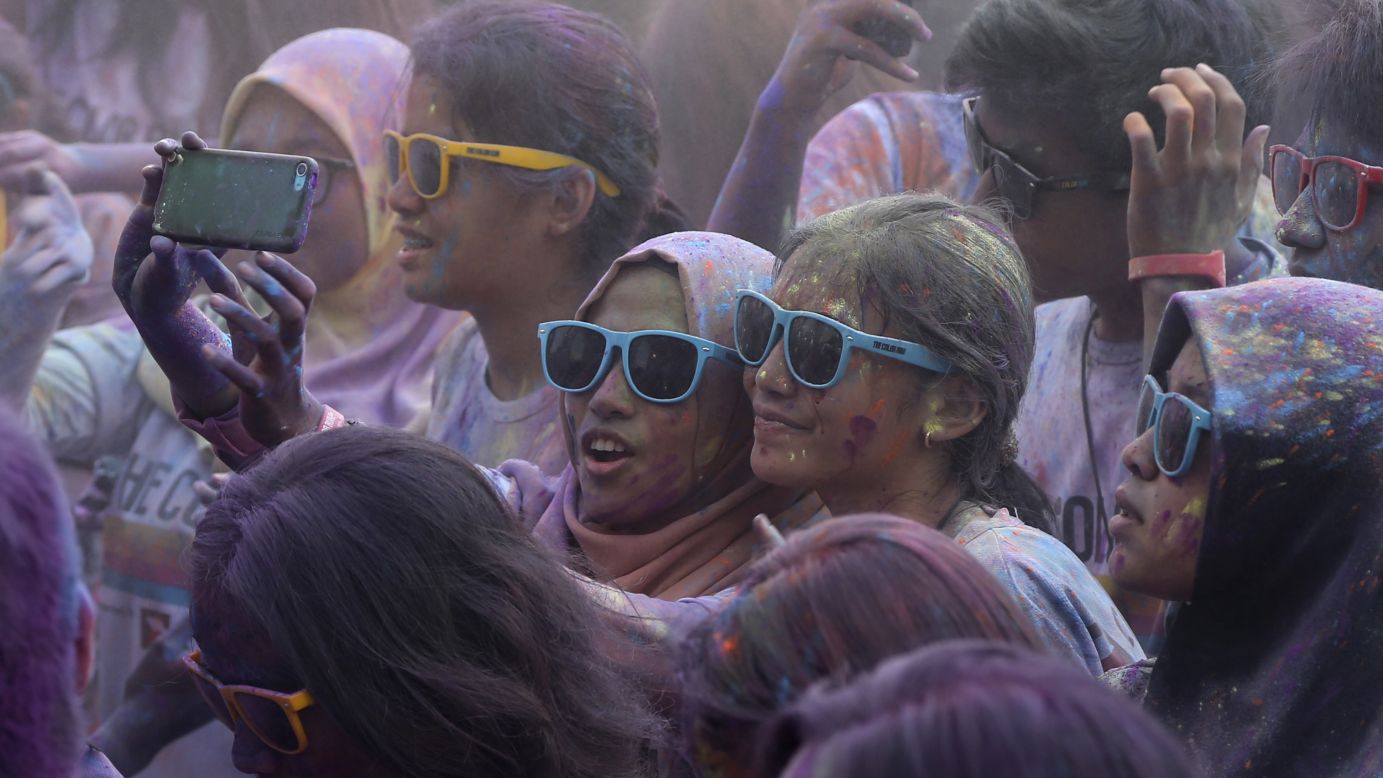 People take a selfie during the Color Run event in Jakarta, Indonesia, on Sunday, November 23. During the race, which is billed as "the happiest 5K on the planet," participants are doused with colored powder.