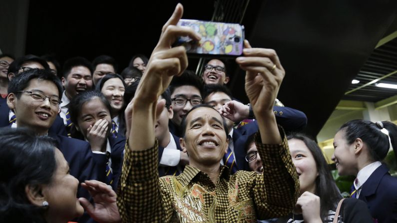 Indonesian President Joko Widodo takes a selfie with his son, top right, and other students after a graduation ceremony at the Anglo-Chinese School in Singapore on Friday, November 21.