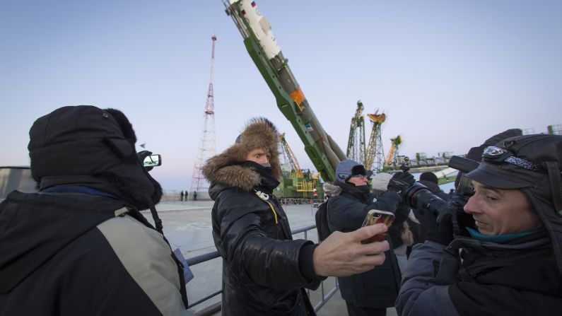 A man takes a selfie as the Soyuz TMA-15M spacecraft is lifted to its launch pad Friday, November 21, at the Baikonur Cosmodrome in Kazakhstan. The Soyuz took off a few days later, carrying three people to the International Space Station.
