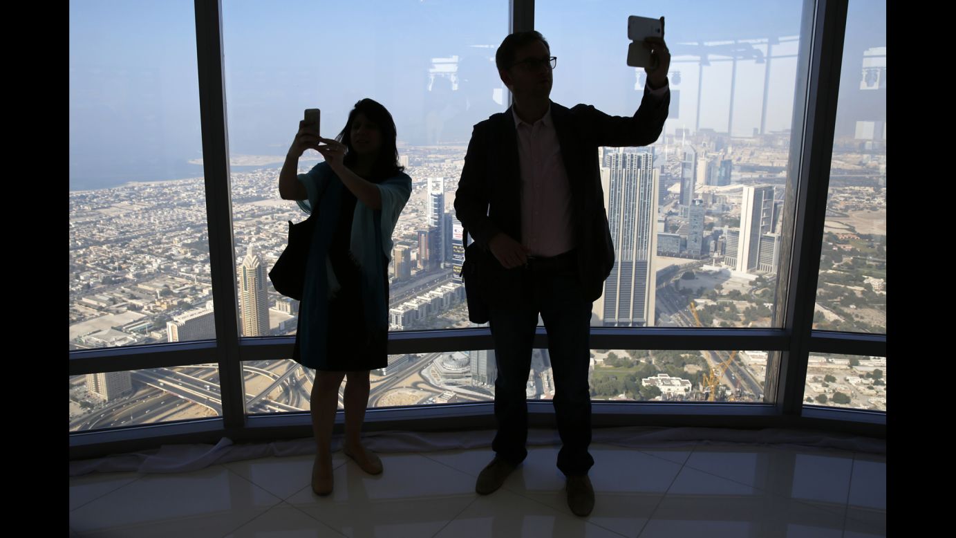 People take selfies from the Burj Khalifa, the tallest building in the world, in Dubai, United Arab Emirates, on Wednesday, November 19.