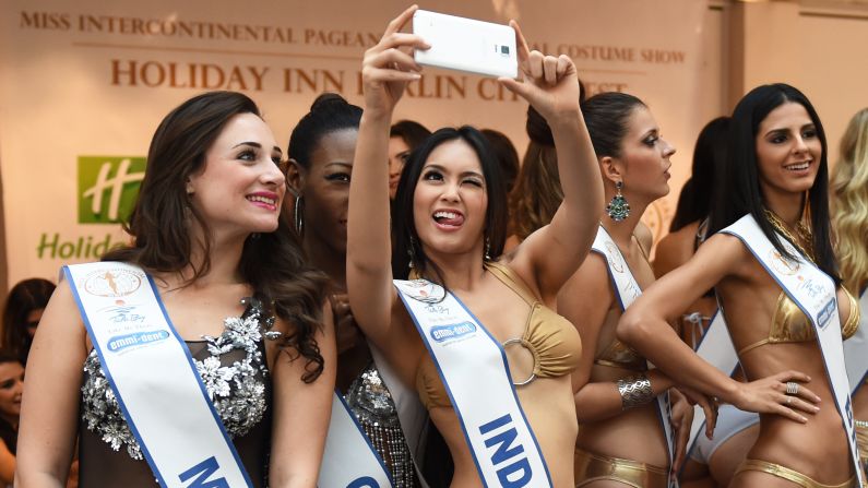 Contestants in the Miss Intercontinental pageant snap a selfie during a photo shoot Tuesday, November 25, in Berlin.