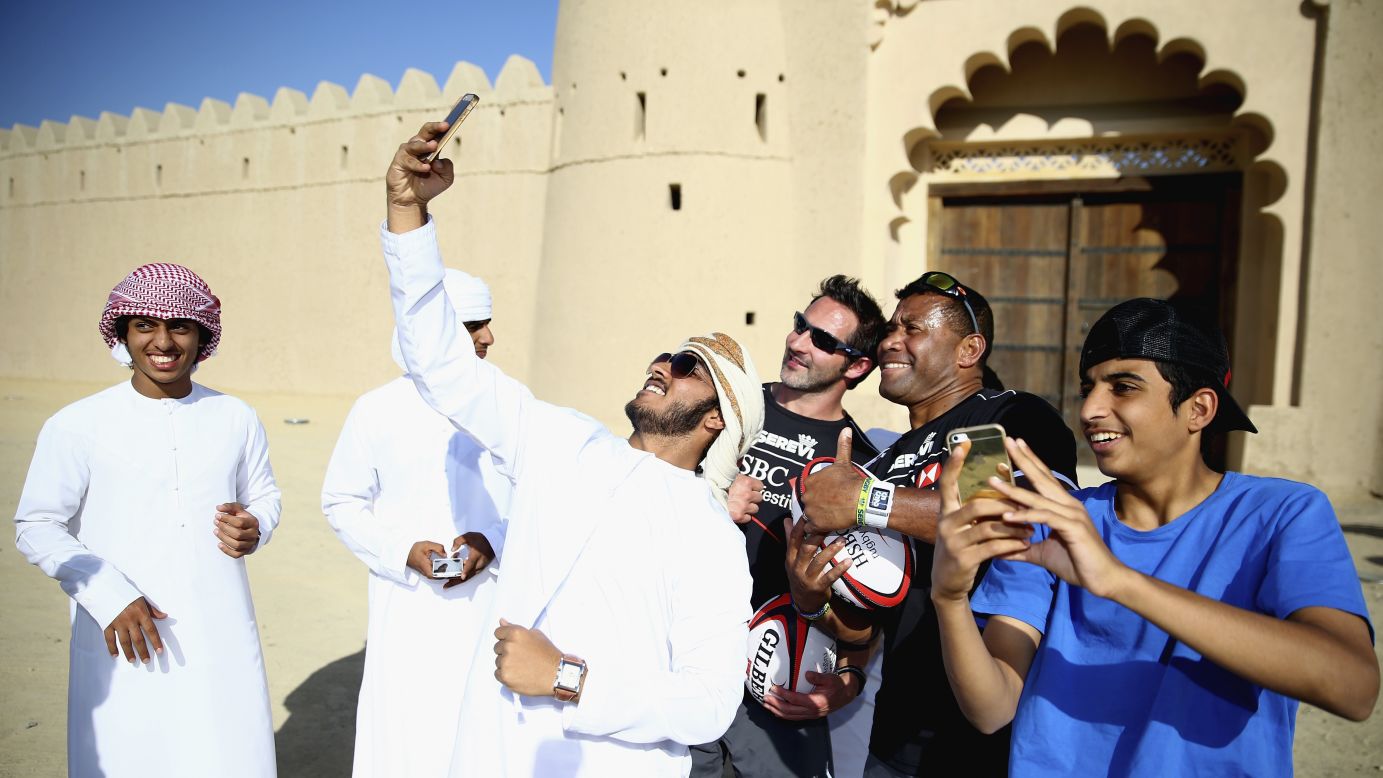 Schoolboys in Al Ain, United Arab Emirates, take selfies with rugby players Ben Gollings and Waisale Serevi during the HSBC Rugby Festival on Monday, November 24.