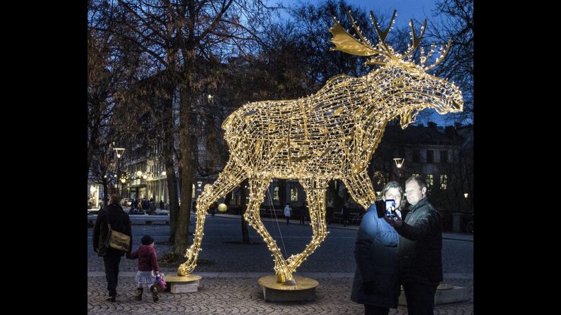 A couple in Stockholm, Sweden, takes a selfie in front of an illuminated Christmas moose on Saturday, November 22. <a href="http://www.cnn.com/2014/11/19/living/gallery/look-at-me-1119/index.html">See 25 selfies from last week</a>