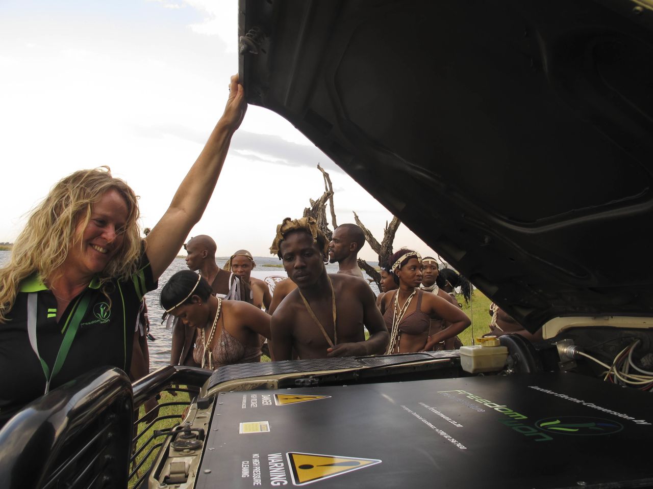 Lizette Kriel, co-owner of electric vehicle company Freedom Won, peeks under the hood of a Land Rover converted from diesel to electric power.