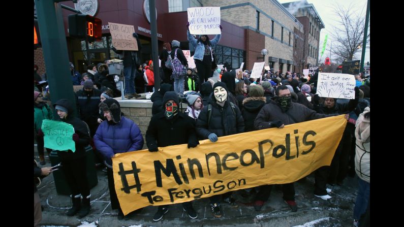 Demonstrators gather November 25 outside the Minneapolis Police Department's Third Precinct to protest Monday's announcement.