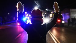 A protester holds her hands up in front of police in Ferguson, Missouri, on Tuesday, November 25.