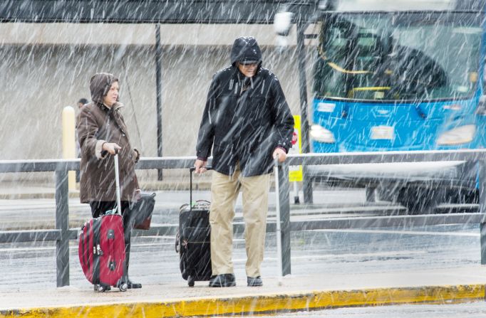 Travelers arrive at Dulles International Airport outside Washington on November 26.