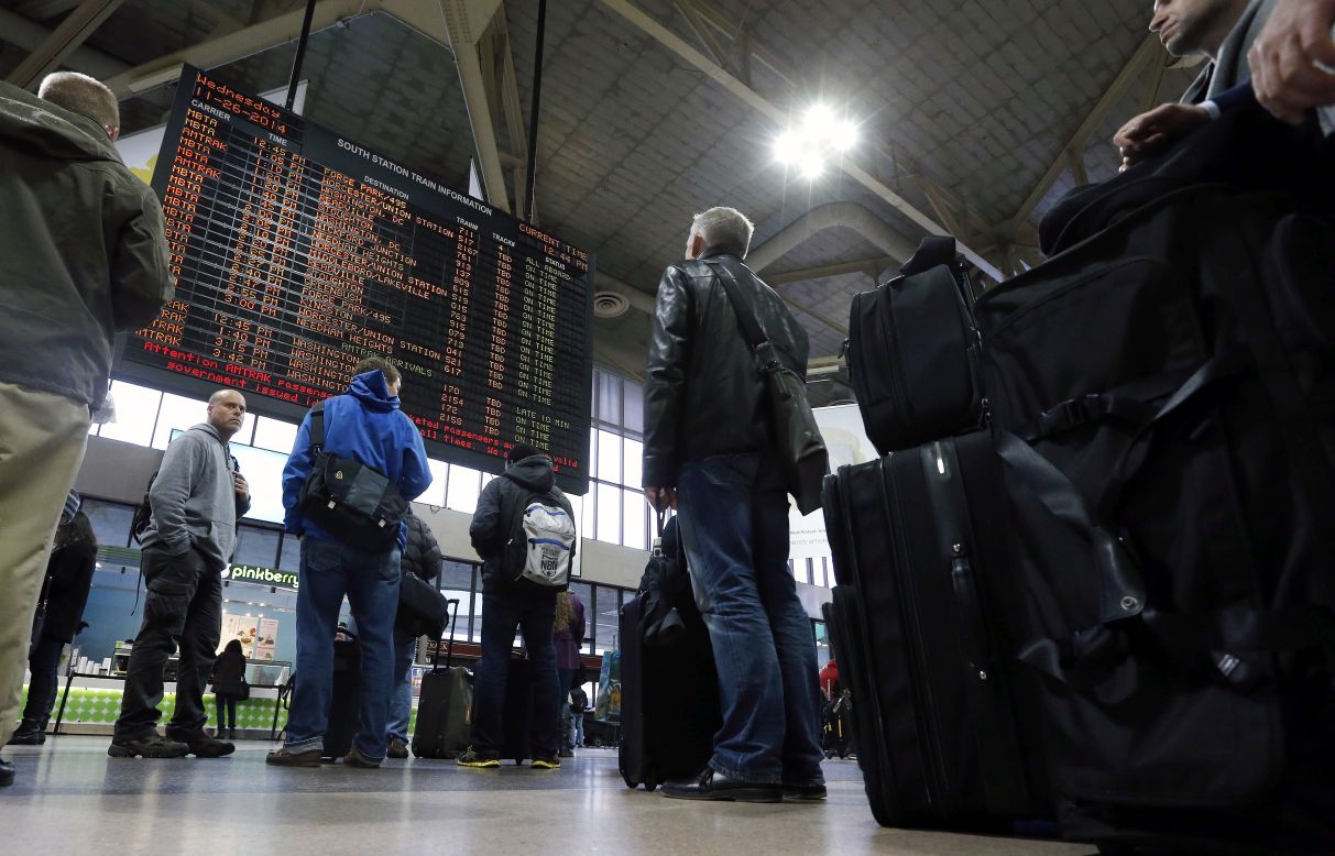 Passengers wait to board trains at Boston's South Station on November 26. 