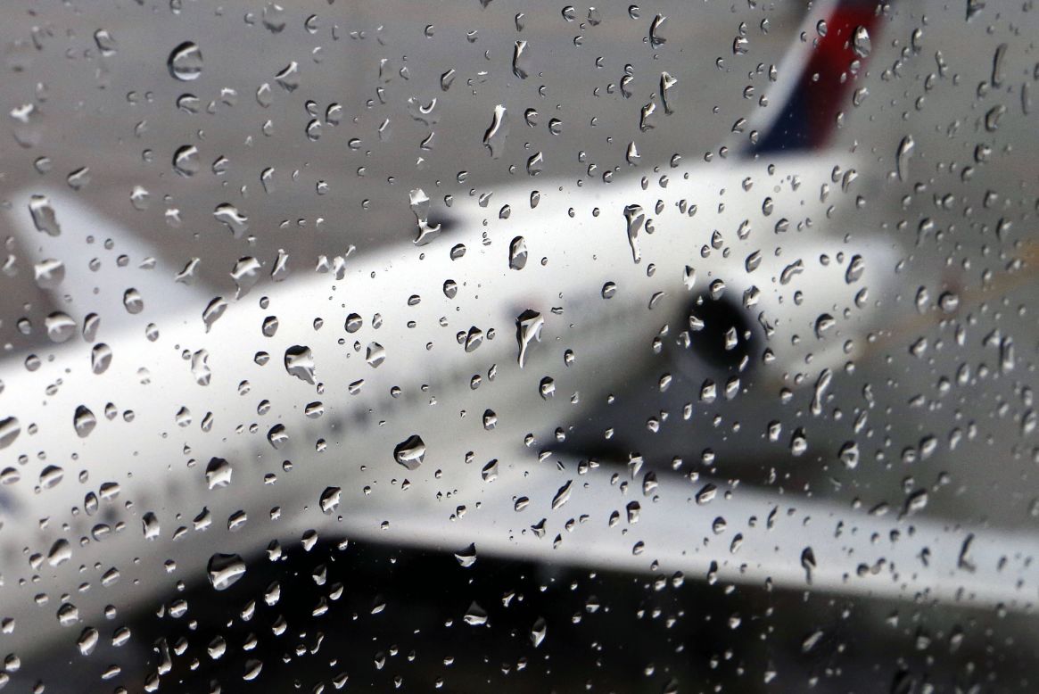 A plane sits on a rainy tarmac November 26 in Boston.