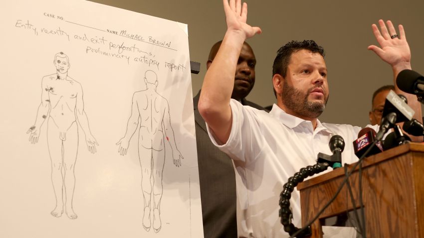 ST LOUIS, MO - AUGUST 18:  Shawn Parcells, a forensic pathologist who assisted in the autopsy of Michael Brown stands near an autopsy diagram showing where the gun shots hit Michael Brown as he speaks about the findings during a press conference at  the Greater St. Marks Family Church on August 18, 2014 in Ferguson, Missouri. Unarmed teenager Michael Brown was shot and killed by a Ferguson police officer on August 9th.  (Photo by Joe Raedle/Getty Images)