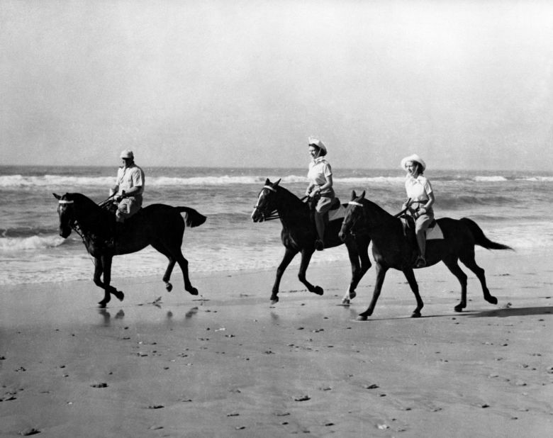 In 1947, while still a princess, Elizabeth (center) is seen riding on a South African beach.