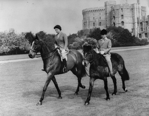 The Queen and her son, the Prince of Wales, riding at Windsor Castle.