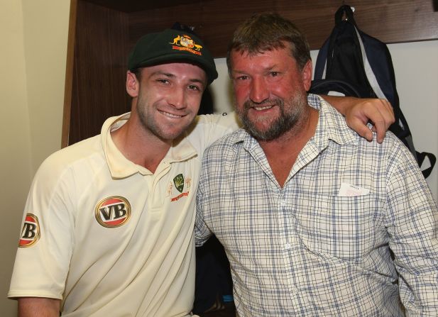 Hughes, whose mother and sister were present at the Sydney Cricket Ground when he suffered his devastating blow, celebrates victory with father Greg following his Test debut with Australia in 2009.