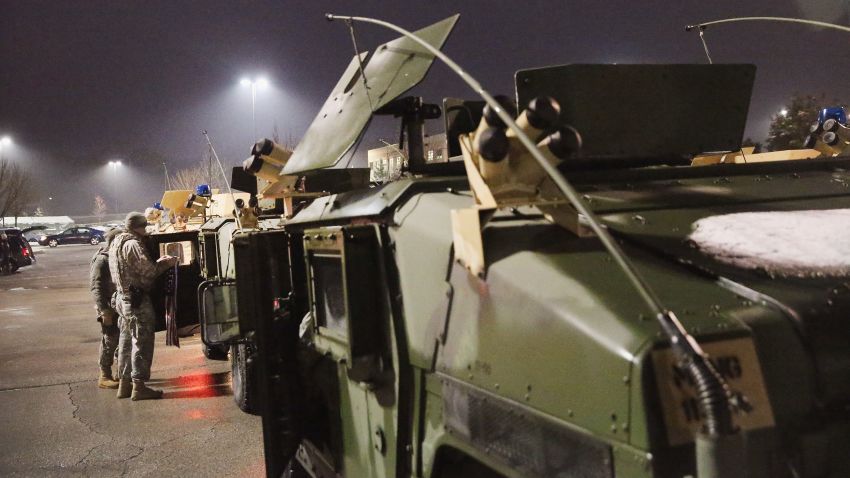 FERGUSON, MO - NOVEMBER 26: National Guard troops, who were called up by the governor to help maintain order, stage at a shopping mall on November 26, 2014 in Ferguson, Missouri. Demonstrators looted and burned down business on Monday after the grand jury announced its decision in the Michael Brown case. Brown, an 18-year-old black man, was killed by Darren Wilson, a white Ferguson police officer, on August 9. (Photo by Scott Olson/Getty Images)