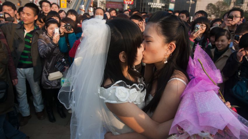 In a picture taken on March 8, 2011 a gay couple kiss during their ceremonial 'wedding' as they try to raise awareness of the issue of homosexual marriage, in Wuhan, in central China's Hubei province. Homosexuality was considered a mental disorder in China until 2001. Today, gays face crushing social and family pressure and many remain in the closet as a result, despite gradual steps towards greater acceptance. CHINA OUT AFP PHOTO (Photo credit should read STR/AFP/Getty Images)