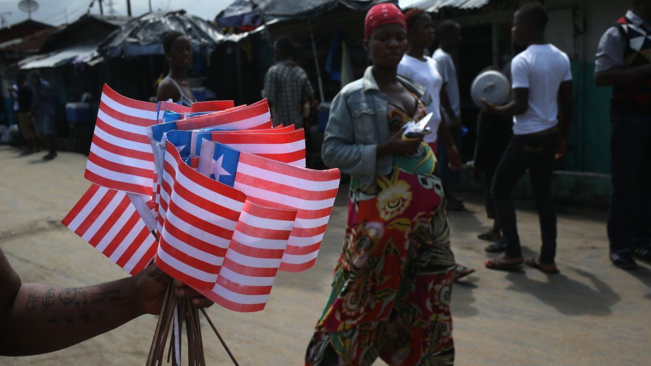A street vendor sells Liberian flags near an Ebola isolation ward on August 15, 2014 in the country's capital of Monrovia. 