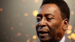 Brazilian football legend Pele answers journalist's questions next to the FIFA World Cup trophy during a press conference, on March 9, 2014 outside the Hotel de Ville in Paris. The FIFA World Cup trophy arrived with its ambassador Pele in Paris on March 9, 2014 and will be exhibited on the Hotel de Ville plaza until March 10. AFP PHOTO / FRANCK FIFE (Photo credit should read FRANCK FIFE/AFP/Getty Images)