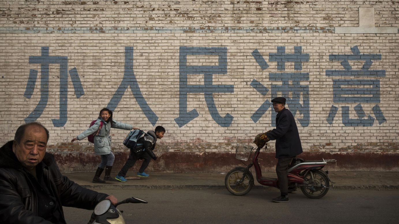 Young students horse around as they walk to school in Hebei, China, on Friday, November 21.