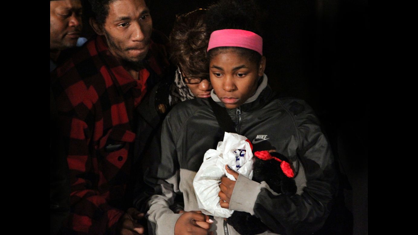 Tamir Rice's big sister clutches a bag of money that was collected for his funeral during a rally in Cleveland on Monday, November 24. A Cleveland police officer <a href="http://www.cnn.com/2014/11/26/justice/cleveland-police-shooting/index.html">shot 12-year-old Tamir</a> about two seconds after the officer and a partner pulled up in a car to investigate reports that someone was brandishing a gun at a park, surveillance video shows. Tamir, who had what police said is an air gun that looked like a real firearm, died Sunday, a day after he was shot.