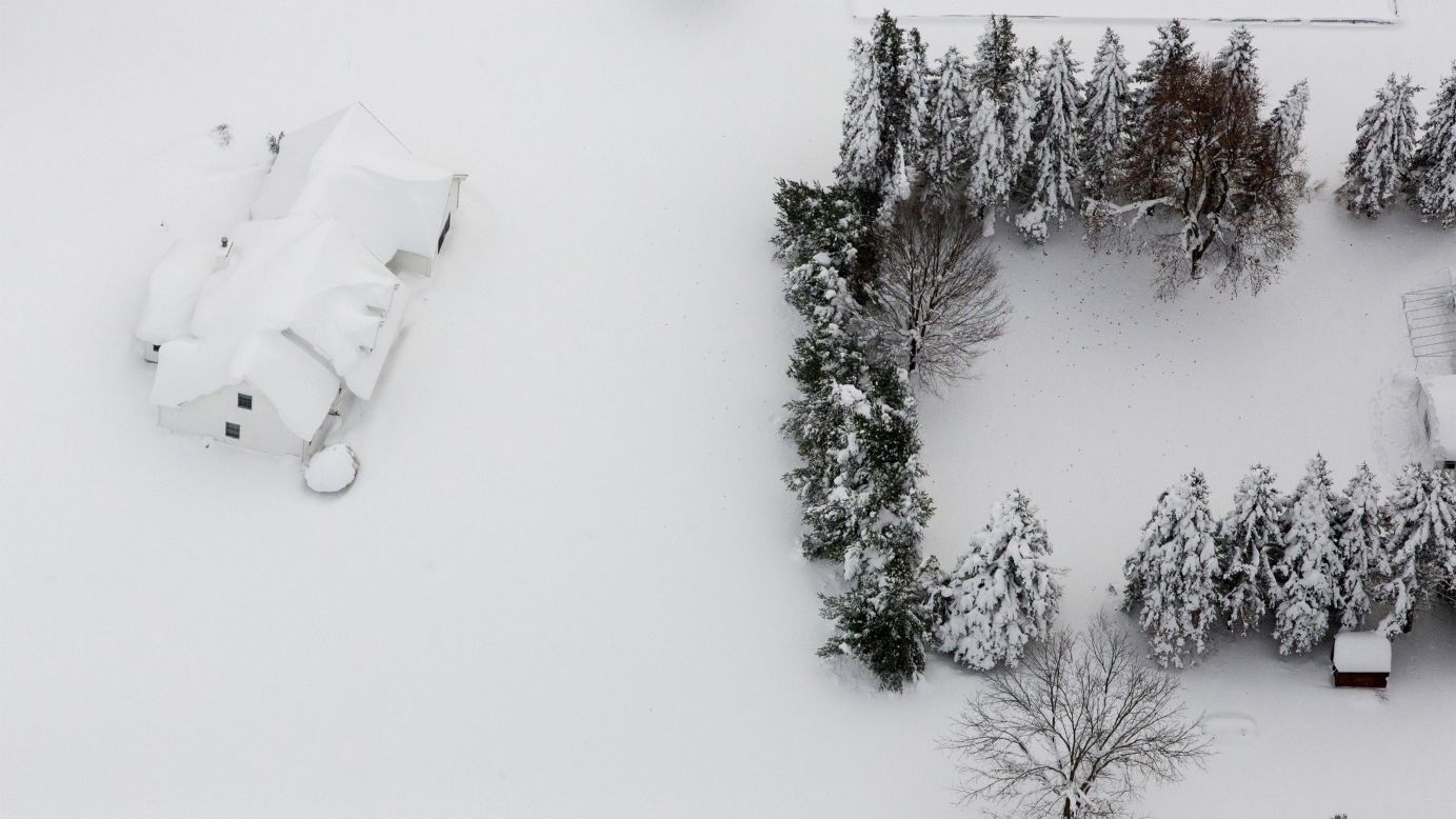 Snow covers a house near Buffalo, New York, on Friday, November 21. A ferocious lake-effect storm <a href="http://www.cnn.com/2014/11/19/us/gallery/wintry-weather/index.html">dumped massive piles of snow</a> on parts of upstate New York, trapping residents in their homes and stranding motorists on roadways.