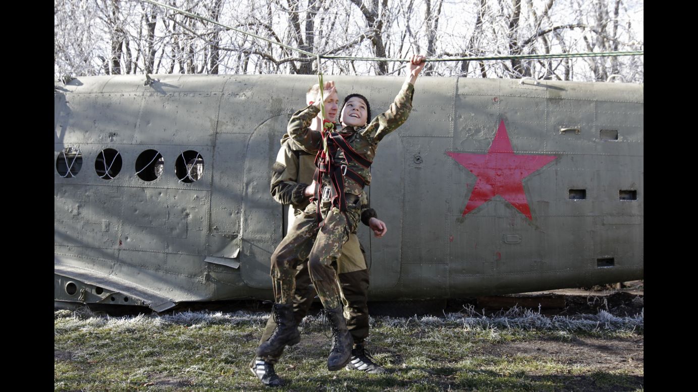 A student from the General Yermolov Cadet School crosses an obstacle Saturday, November 22, during a competition between school classes in Stavropol, Russia. The school is a state-run institution that teaches military and patriotic classes in addition to a normal syllabus.