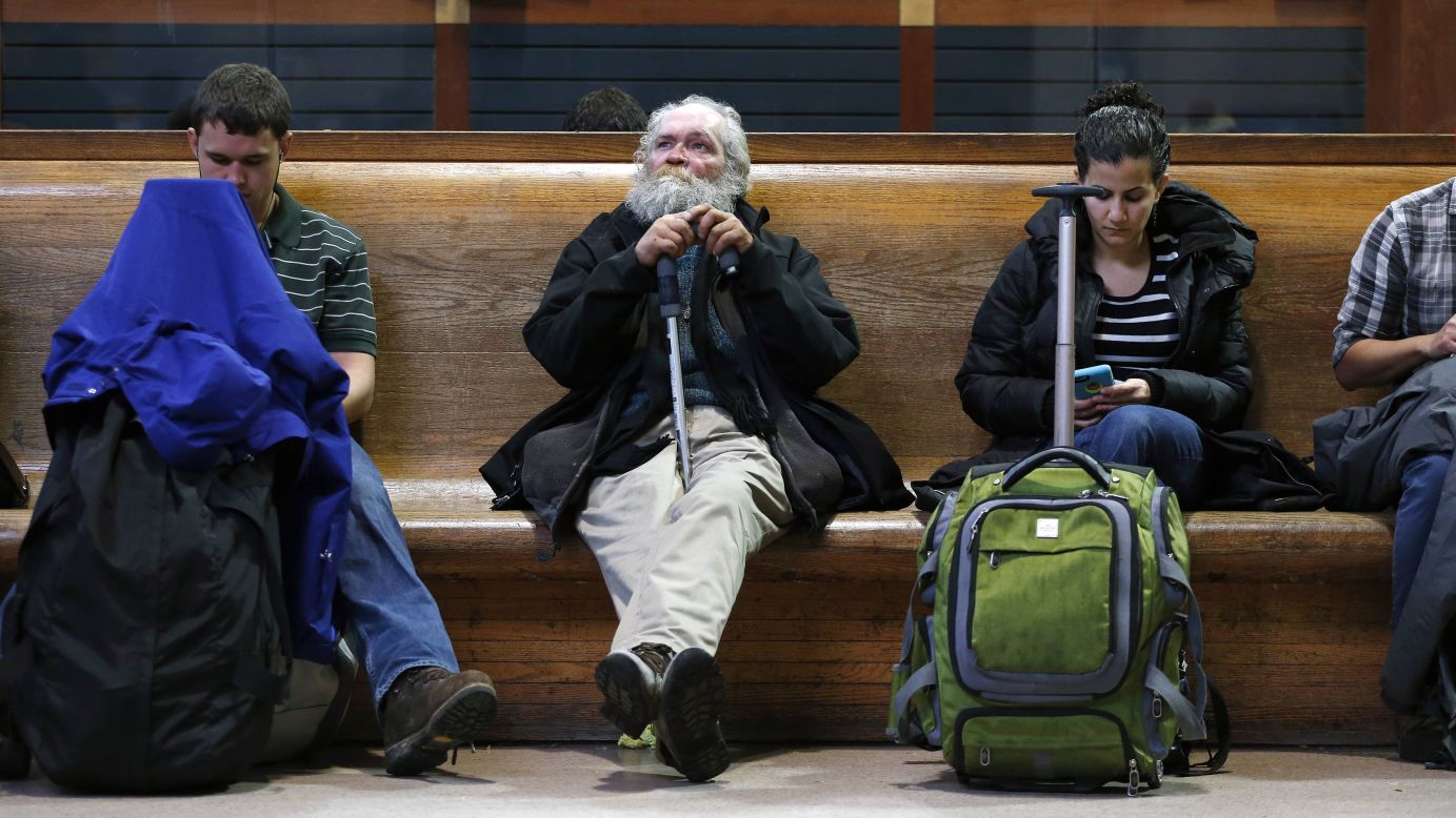 Travelers sit in the waiting area of Boston's South Station on Wednesday, November 26.