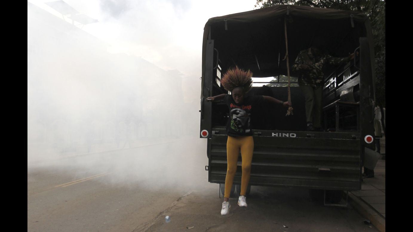 A detained protester jumps from a police truck after riot police released tear gas to disperse a demonstration Tuesday, November 25, in Nairobi, Kenya. Protesters called on President Uhuru Kenyatta to "stop the killings" after <a href="http://www.cnn.com/2014/11/22/world/africa/kenya-bus-attack/index.html">28 people were slaughtered</a> in a weekend attack claimed by Islamist militants. According to authorities, the militants ambushed a bus and shot those who failed to recite Quran verses.
