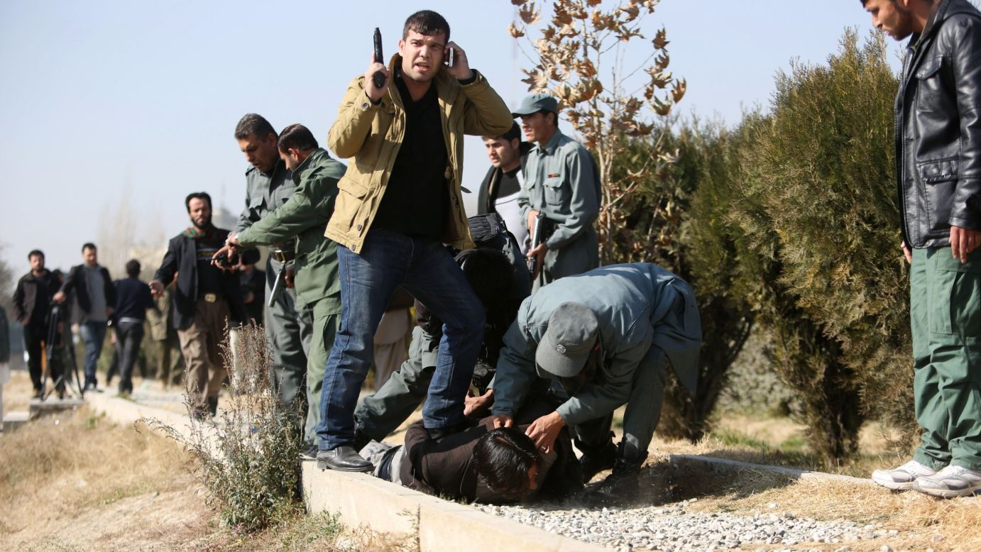 Afghan security personnel arrest a suspect after a bomb explosion in Kabul, Afghanistan, on Tuesday, November 25.