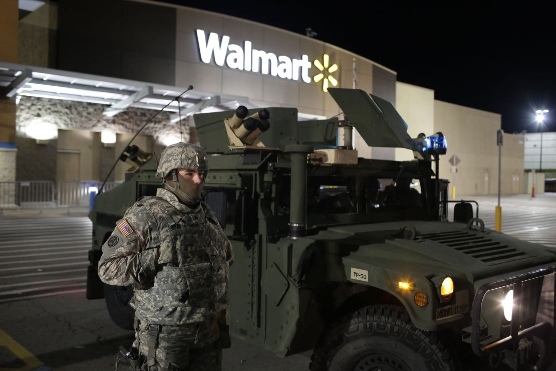 A National Guard troop stands outside of a closed Walmart on Thursday in Ferguson.