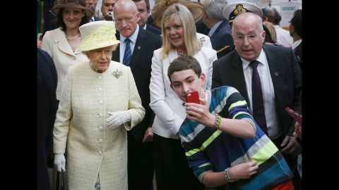 A boy in Belfast, Northern Ireland, takes a selfie in front of Britain's Queen Elizabeth II on Tuesday, June 24.