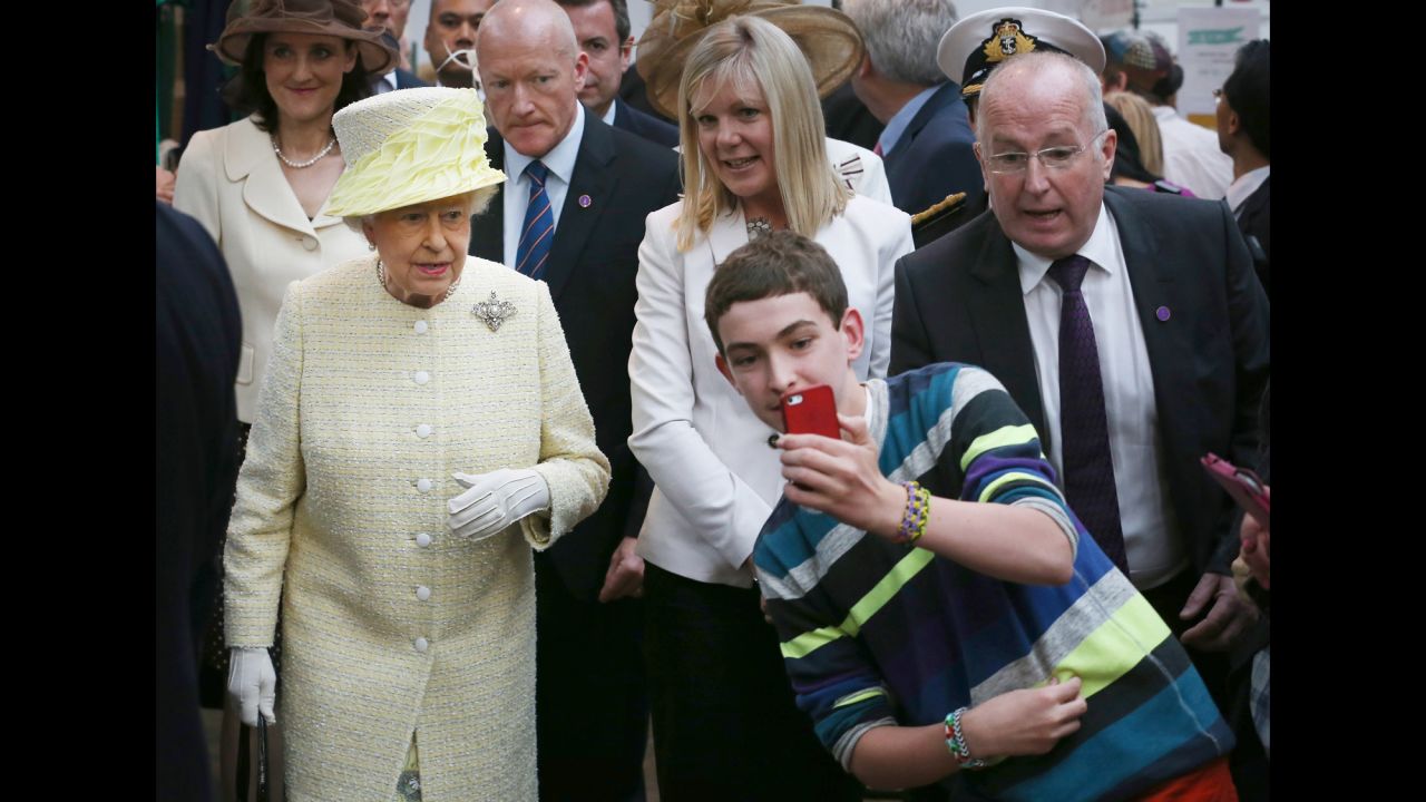 A boy in Belfast, Northern Ireland, takes a selfie in front of Britain's Queen Elizabeth II on Tuesday, June 24.