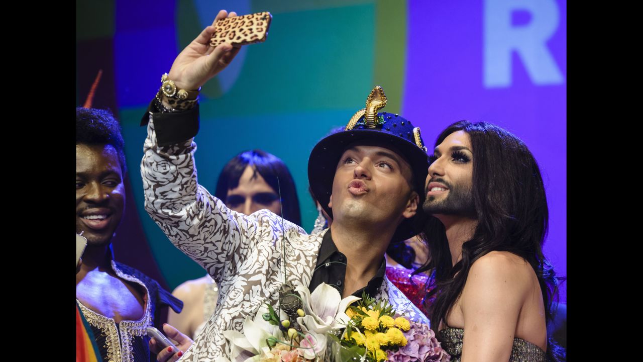 German actor Julian Stoeckel takes a selfie with Austrian singer Conchita Wurst, right, during a gala in Berlin on Friday, June 20. Wurst, the onstage drag persona of Thomas Neuwirth, won this year's <a href="http://www.cnn.com/2014/05/11/world/europe/eurovision-ukraine-russia-conchita-wurst/index.html">Eurovision Song Contest.</a>