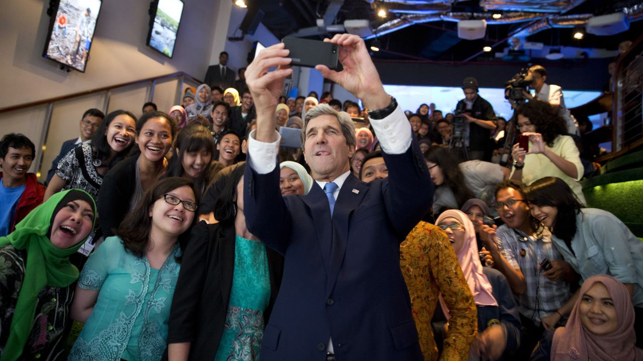 U.S. Secretary of State John Kerry takes a selfie with a group of students in Jakarta, Indonesia, before delivering <a href="http://www.cnn.com/2014/02/16/politics/kerry-climate/index.html">a speech on climate change</a> on Sunday, February 16.