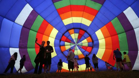People walk around a partially inflated hot-air balloon Sunday, July 27, at the New Jersey Festival of Ballooning in Readington, New Jersey.