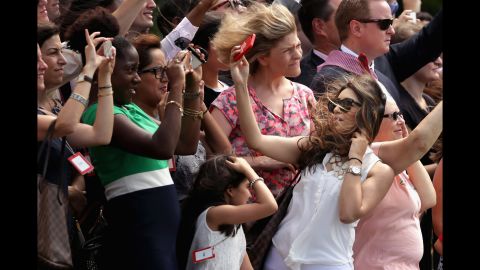 A woman takes a selfie in Washington as a helicopter carrying U.S. President Barack Obama takes off from the White House on Thursday, June 26.