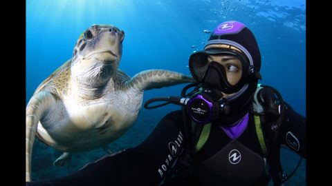 An underwater photographer gets a selfie with a sea turtle Wednesday, September 17, off the coast of Tenerife, one of Spain's Canary Islands.