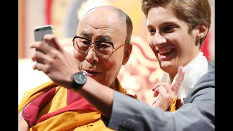 The Dalai Lama poses for a selfie during an event in Hamburg, Germany, on Sunday, August 24.