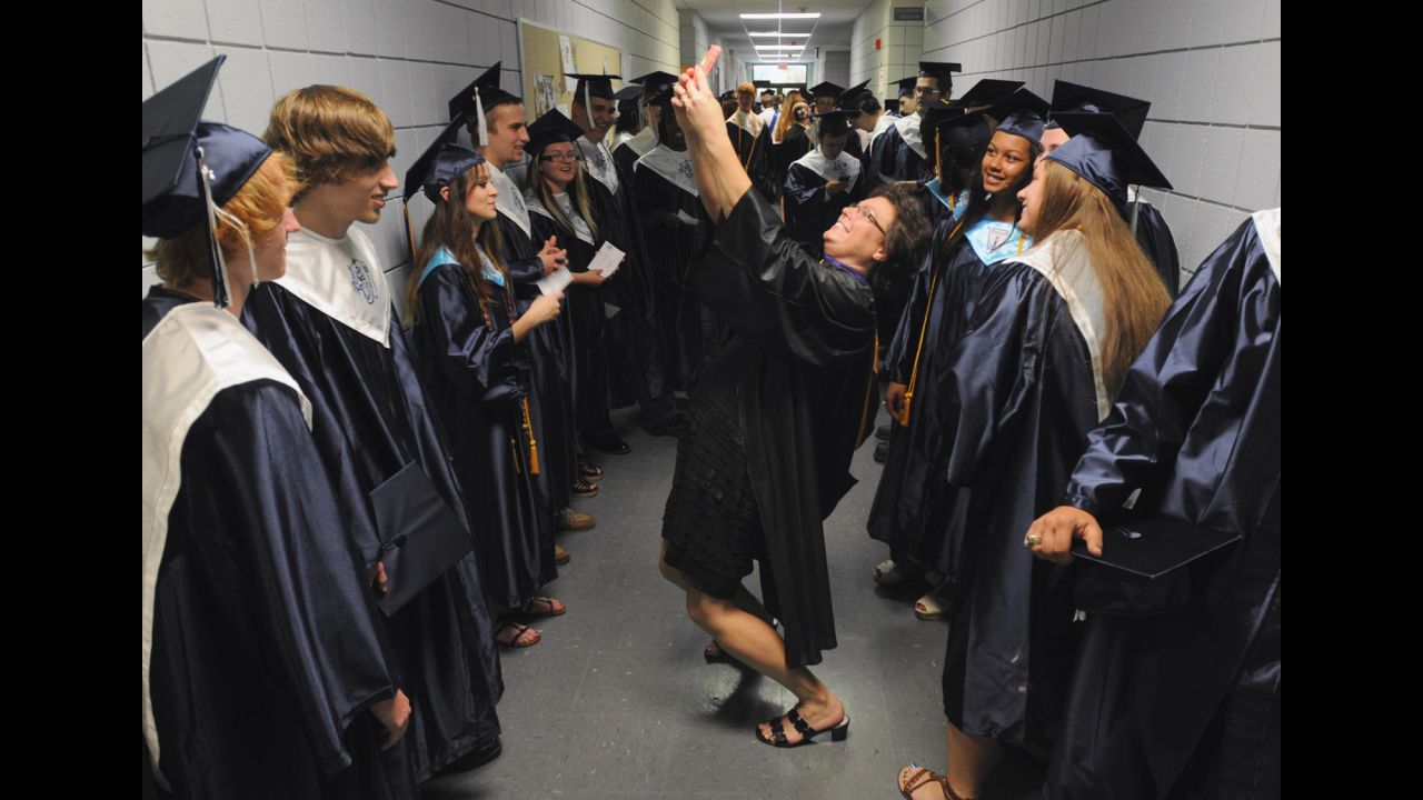 Teacher Cathy Johnson pauses to take a selfie with graduates of South Brunswick High School on Saturday, June 14, in Bolivia, North Carolina.