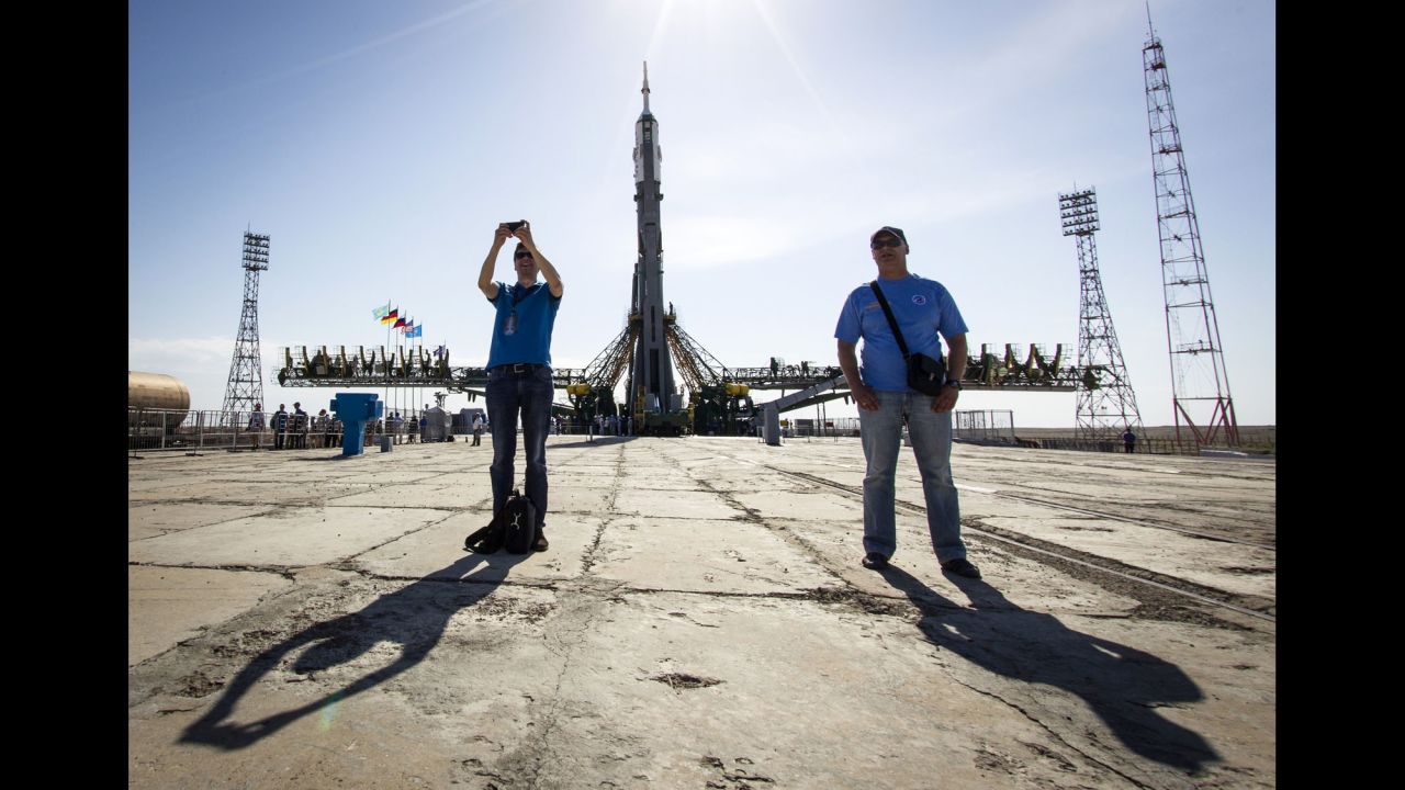 The Soyuz TMA-13M spacecraft is seen behind a man taking a selfie Monday, May 26, at the Baikonur Cosmodrome in Kazakhstan. The Soyuz launched three men to the International Space Station.