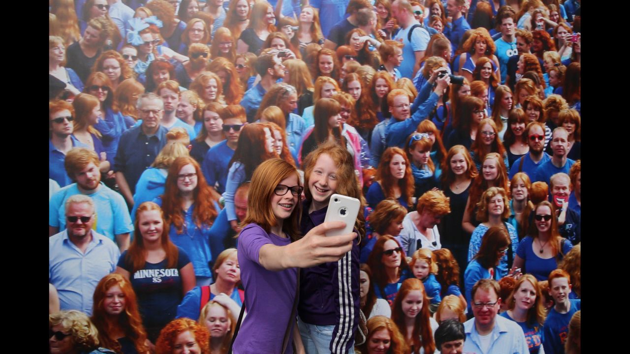 Two girls with red hair take a selfie in front of a picture while taking part in "Redhead Days" in Breda, Netherlands, on Sunday, September 7. <a href="http://www.redheaddays.nl/en/" target="_blank" target="_blank">"Redhead Days"</a> is celebrated annually in the Dutch city, offering music, a fashion show, art exhibitions and other cultural events from and for the red-haired community.