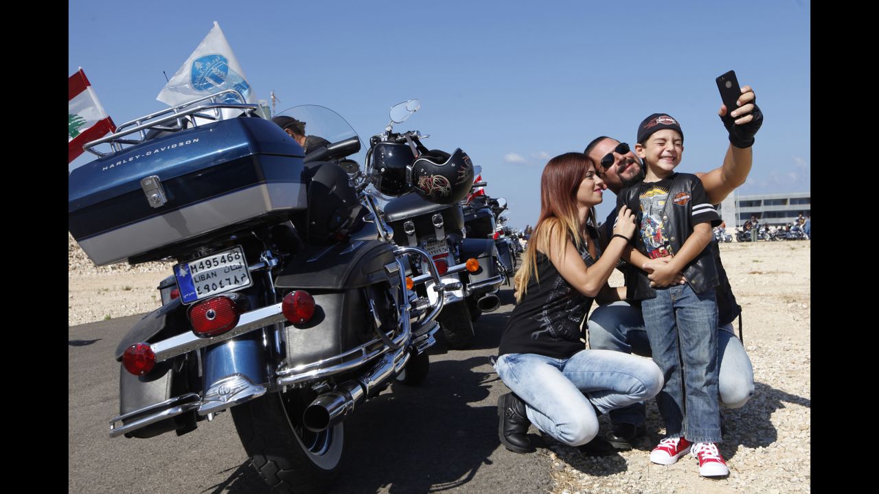 A family takes a selfie together during the Beirut Bike Festival in Beirut, Lebanon, on Sunday, September 21. More than 1,000 motorcycling enthusiasts took part in the event, which organizers say promotes safe and legal motorcycling habits in Lebanon.