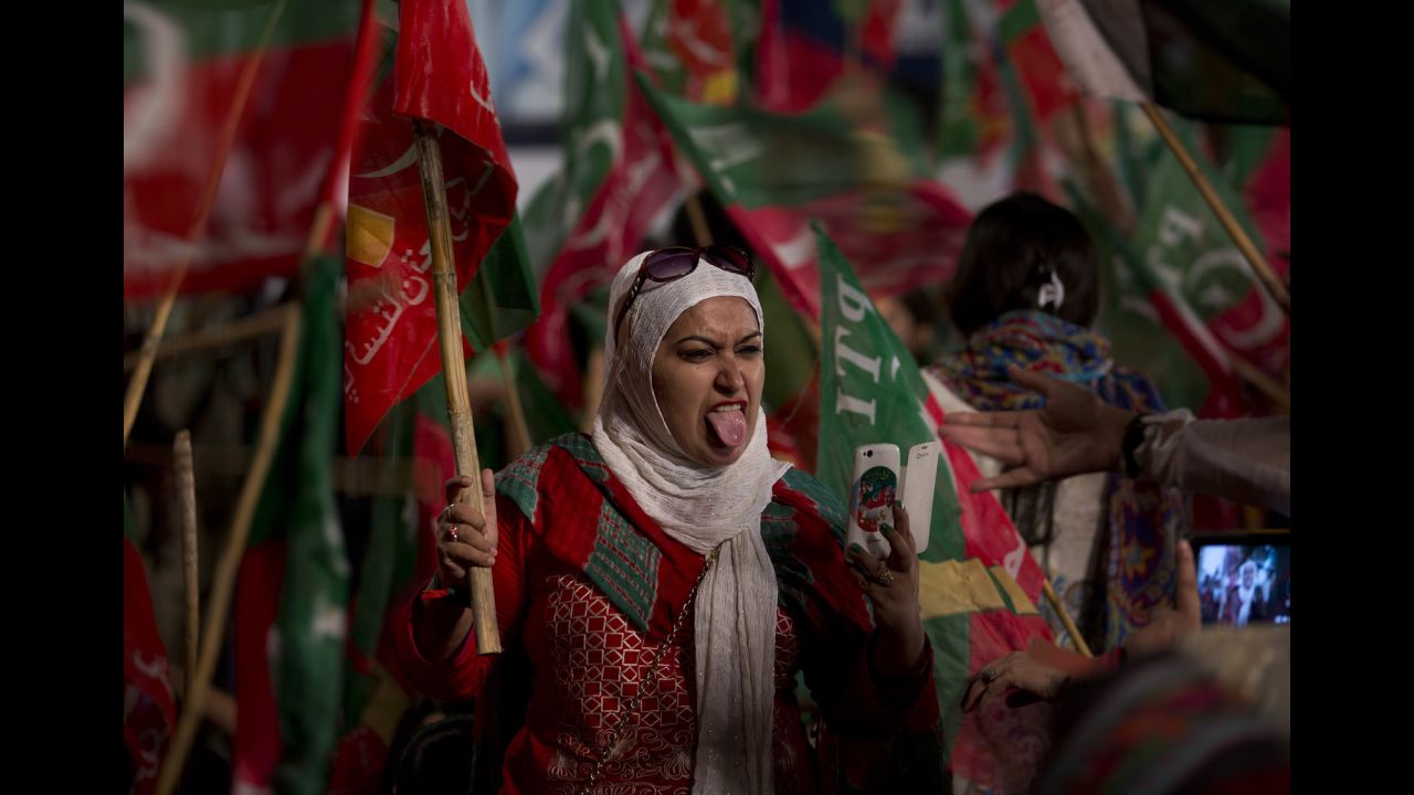 A supporter of Pakistani politician Imran Khan sticks out her tongue while taking a selfie during a rally in Islamabad, Pakistan, on Saturday, August 23.