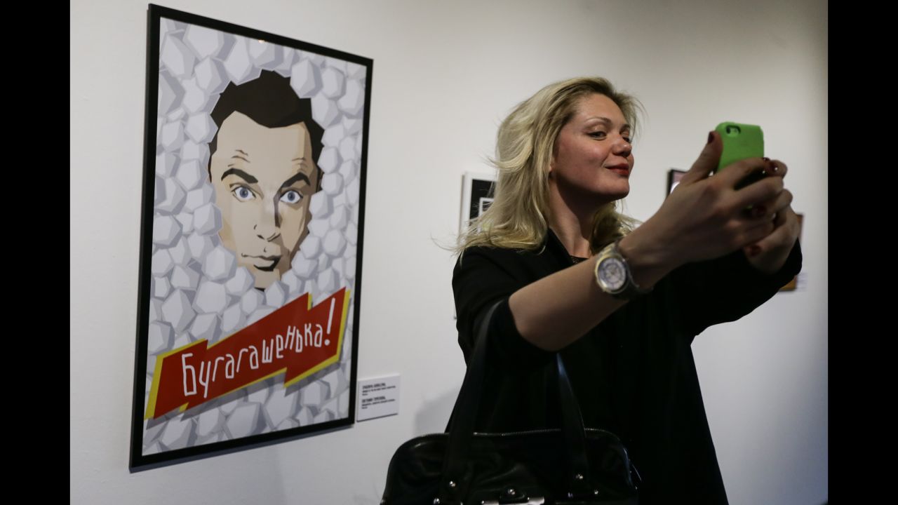 A visitor of Moscow's Solyanka Gallery gets a selfie in front of a Sheldon Cooper portrait on Monday, November 17. Cooper, played by actor Jim Parsons, is one of the main characters on the hit television show "The Big Bang Theory."